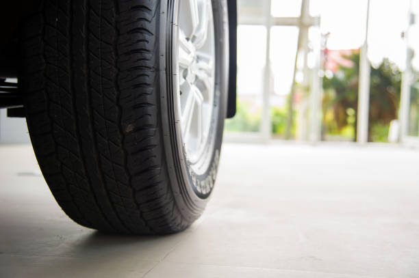 istock closeup car wheels with soft-focus and over light in the background 1053499546