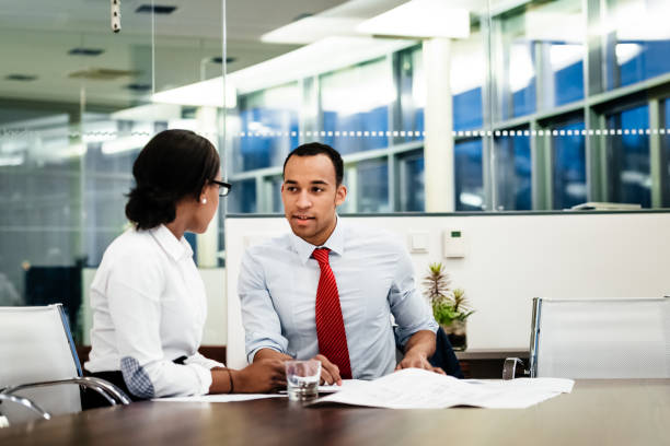 istock Office Colleagues Talking And Reviewing Paperwork 1053500022