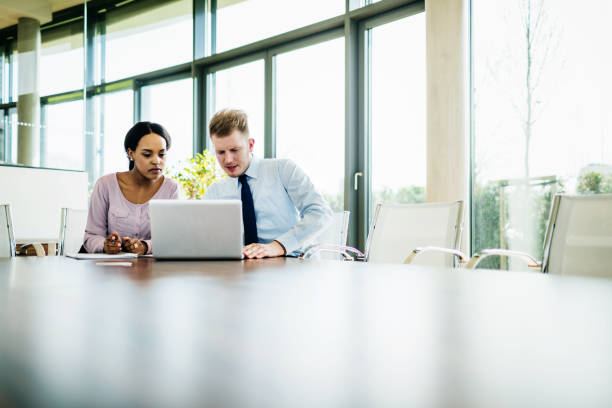 istock Two Business Partners Working On Laptop 1053501606