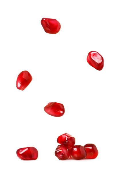 istock Ripe red pomegranate grains isolated on white background 1053501736