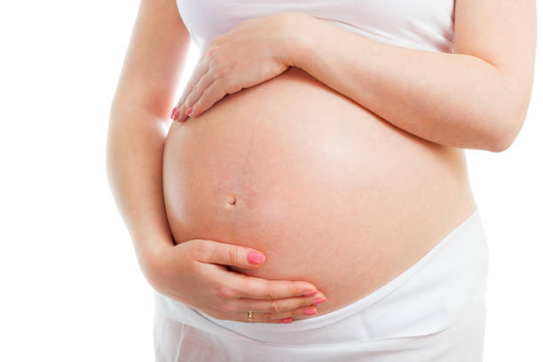 A cute pregnant belly isolated on white