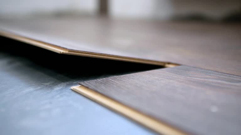 Homeowner installs brown laminate flooring.