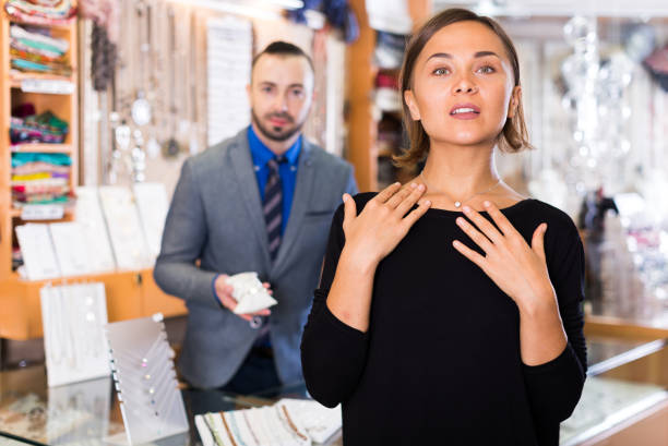 istock woman choosing chainlet and pendants 1053509158