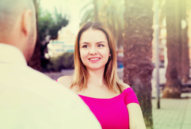 istock Young female is flirting with guy 1053510762