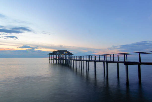 istock Pier Over Sea Against Sky During Sunset 1053512384