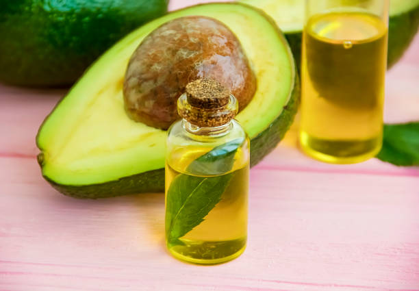 istock fresh avocado oil on a pink wooden background 1053515098