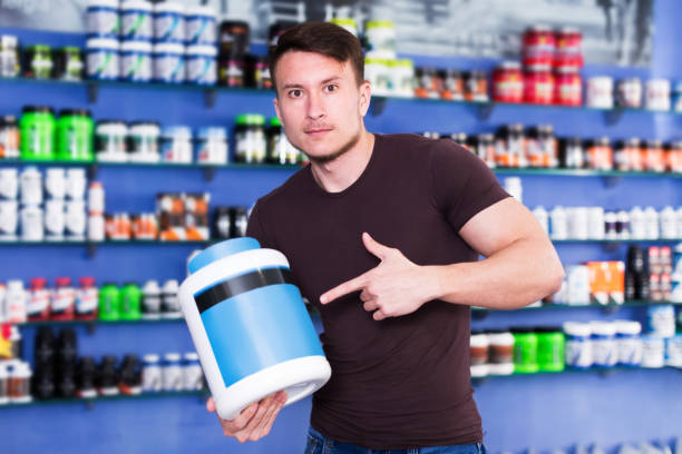 istock Guy holding sport food supplements 1053515216