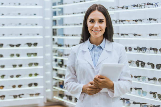 istock attractive professional optician with digital tablet looking at camera in ophthalmic shop 1053515882