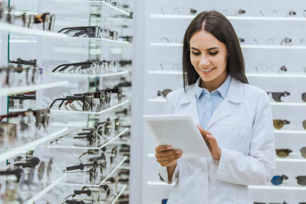 istock professional optometrist using digital tablet near shelves with eyesight in optica 1053515984