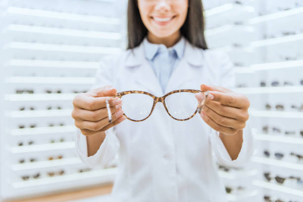 istock cropped view of professional optometrist holding eyeglasses 1053516044