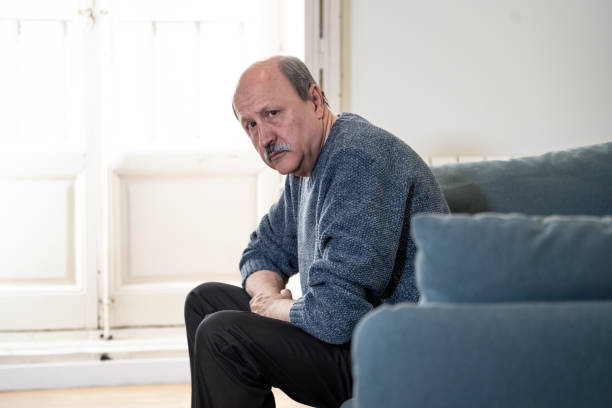 istock Senior old man feeling desperate sad looking worried depressed thoughtful and lonely on couch at home in Aging Mental health Personal problems and Life style concept. 1053516672