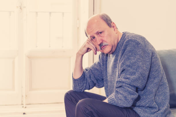 istock Overwhelmed old senior man suffering alone at home feeling confused sad alone on couch at home in Aging Retirement widower Dementia and Alzheimer concept. 1053516702