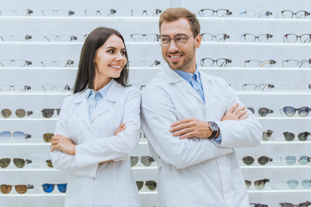istock professional smiling oculists standing with crossed arms in ophthalmology 1053516838