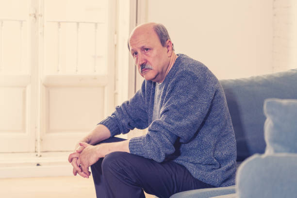 istock Overwhelmed old senior man suffering alone at home feeling confused sad alone on couch at home in Ageing Retirement widower Dementia and Alzheimer concept. 1053516930