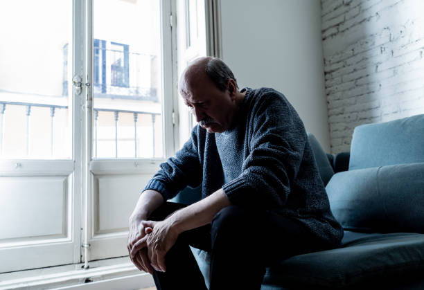 istock Overwhelmed old senior man suffering alone at home feeling confused sad alone on couch at home in Aging Retirement widower Dementia and Alzheimer concept. 1053517244