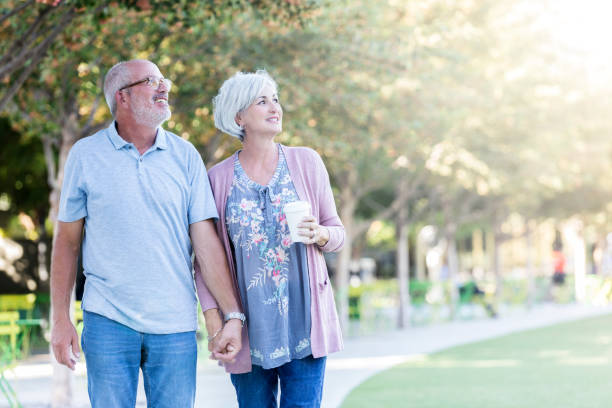 istock Senior couple enjoy walking together in park 1053521796