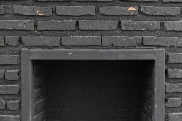 empty fireplace with black cement brick wall. stock photo