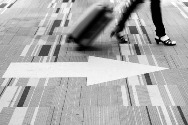 istock Motion blur woman dragging travel suitcase 1053522396