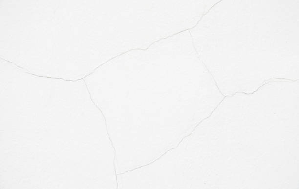 istock Close up a little crack of white wall for decorative background texture 1053523286