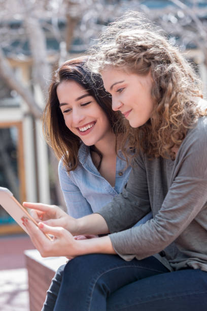 istock Female friends look at digital tablet 1053524668