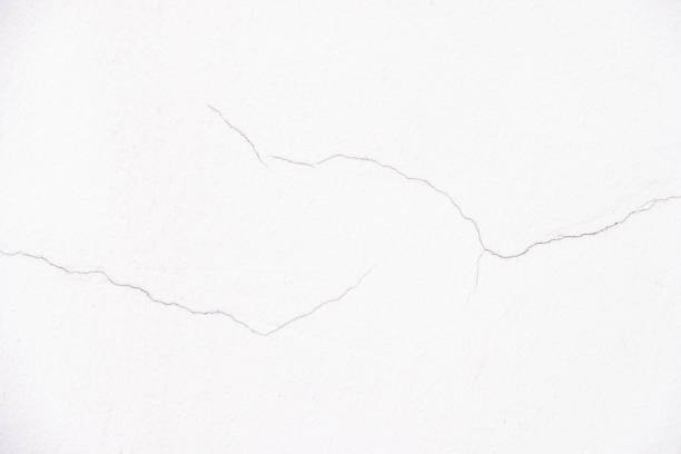Close up a little crack of white wall for decorative background texture