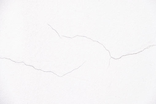 Close up a little crack of white wall for decorative background texture use for cover page and backdrop.