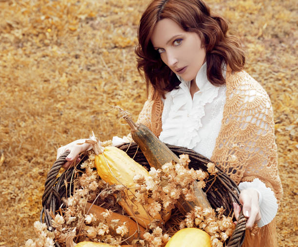 istock Woman with pumpkins 1053525052