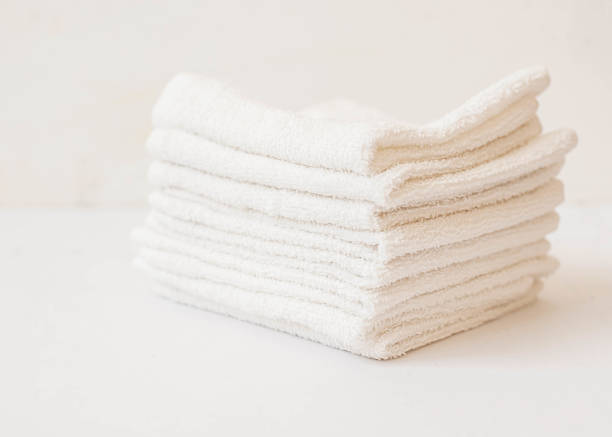 istock white towel on blue background . White Spa towels on blue background, top view 1053525850