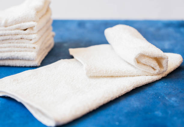 istock white towel on blue background . White Spa towels on blue background, top view 1053525880