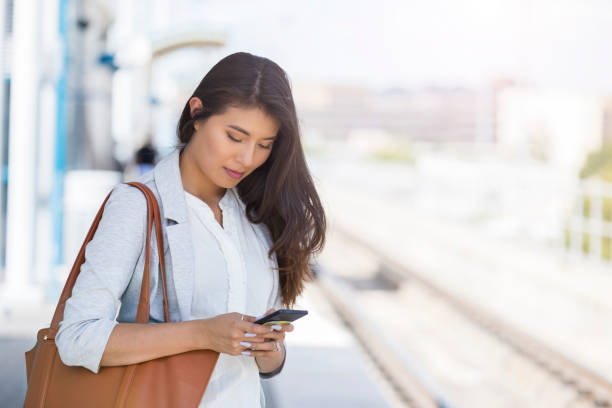 istock Woman waiting for commuter train 1053526158