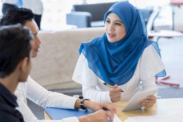 istock Malaysian businesswoman meets with clients 1053526236