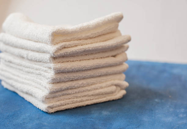 istock white towel on blue background . White Spa towels on blue background, top view 1053526272