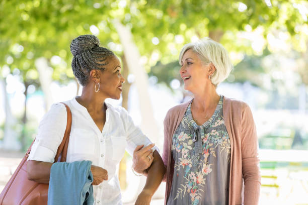 istock Joyful female friends walk together 1053526452