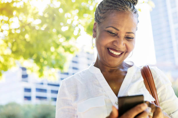 istock Woman texts while outdoors 1053526534