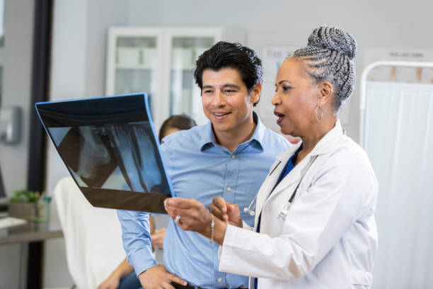 istock Doctor reviews patient's x-ray 1053526688