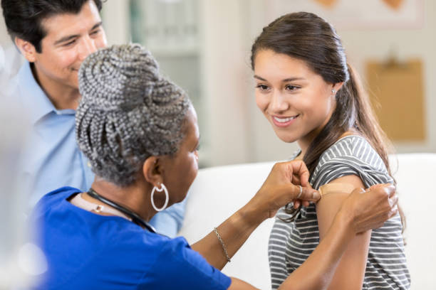 istock Nurse places bandage on female patient 1053526764