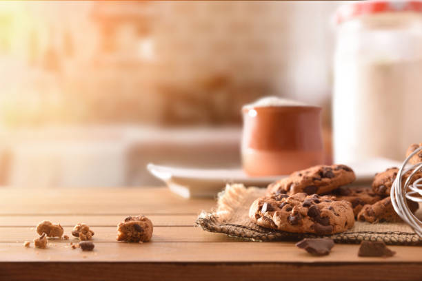 istock Homemade biscuits with chocolate chips on wooden slatted table front 1053527728