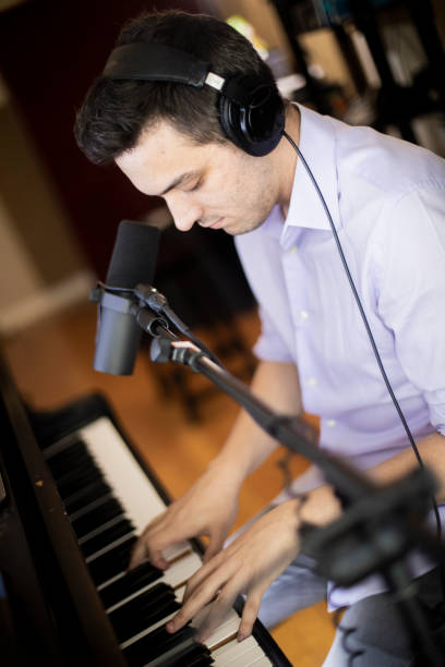 istock Piano Music Streamer Playing in Home Studio 1053527952