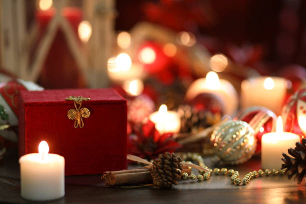 istock Christmas holiday decorations, candles, gift on table. 1053527954
