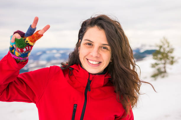 istock Happy woman on a on snow covered mountain 1053532492