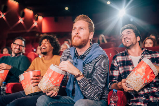 istock A man at cinema with friends 1053538304