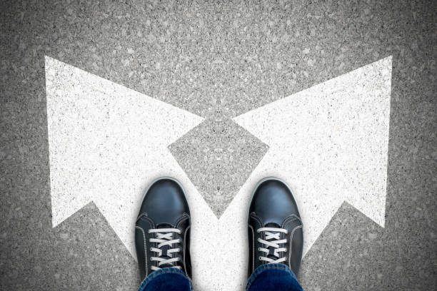 istock One standing at the crossroad making decision 1053540122