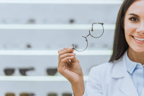 istock attractive smiling optometrist holding eyesight in optica 1053540470