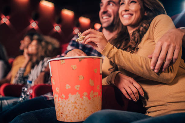 istock Hugging couple eating popcorn at cinema 1053540764