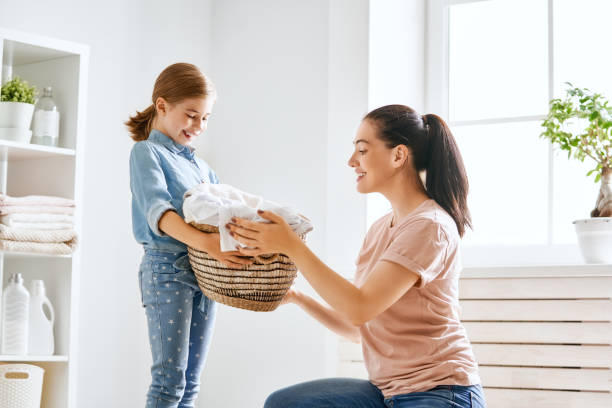 istock family doing laundry at home 1053541260
