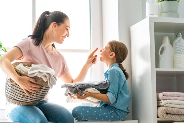 istock family doing laundry at home 1053541510