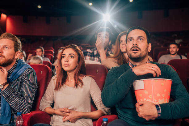 istock Young man eating popcorn in cinema 1053541950