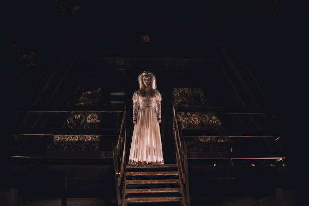 Scary witch standing on porch