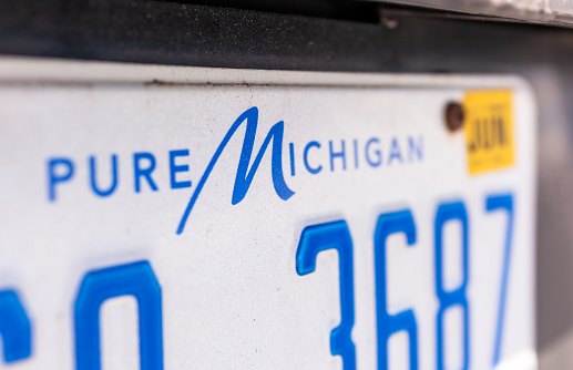 Spanish Fork, Utah - Close-up on the words 'Pure Michigan', at the top of a license plate for a vehicle registered in the state.