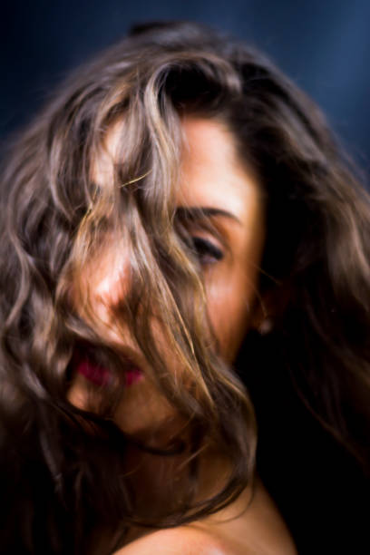 istock Beautiful woman on black background 1053546008